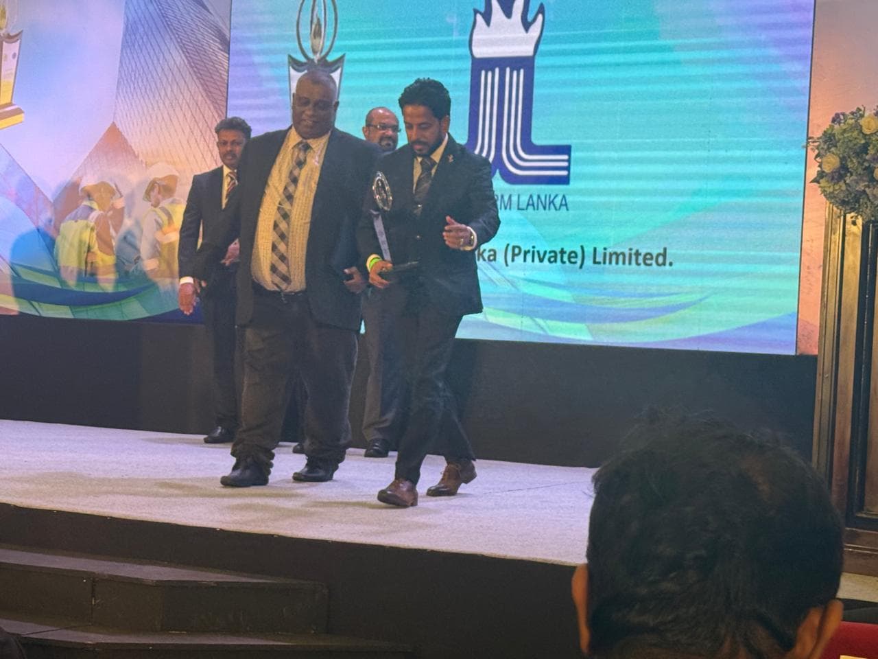 Maxtherm Lanka receiving the award certificate on stage